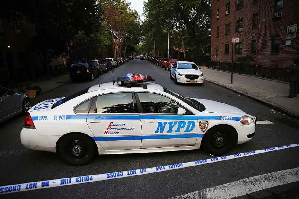 NEW YORK, NY - JUNE 10: A police car is parked at a crime scene where three people were shot on June 10, 2015 in the Gowanus area of the Brooklyn Borough of New York City. In an effort to combat the rise in murders and shootings, hundreds of additional New York City Police Officers will begin walking city streets as part of an aggressive NYPD initiative called "Summer All Out." About 330 officers will be taken off of administrative duty to patrol the streets in some of the city's most violent neighborhoods.