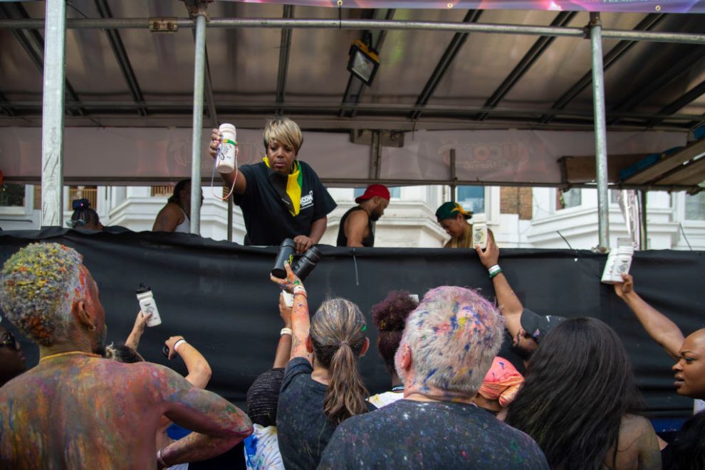 Party goers are given free rum punch at the Notting Hill Carnival, on 25th August, 2019 in London, United Kingdom. One million people are expected on the streets in scorching temperatures for the Notting Hill Carnival, Europe's largest street party and a celebration of Caribbean traditions.