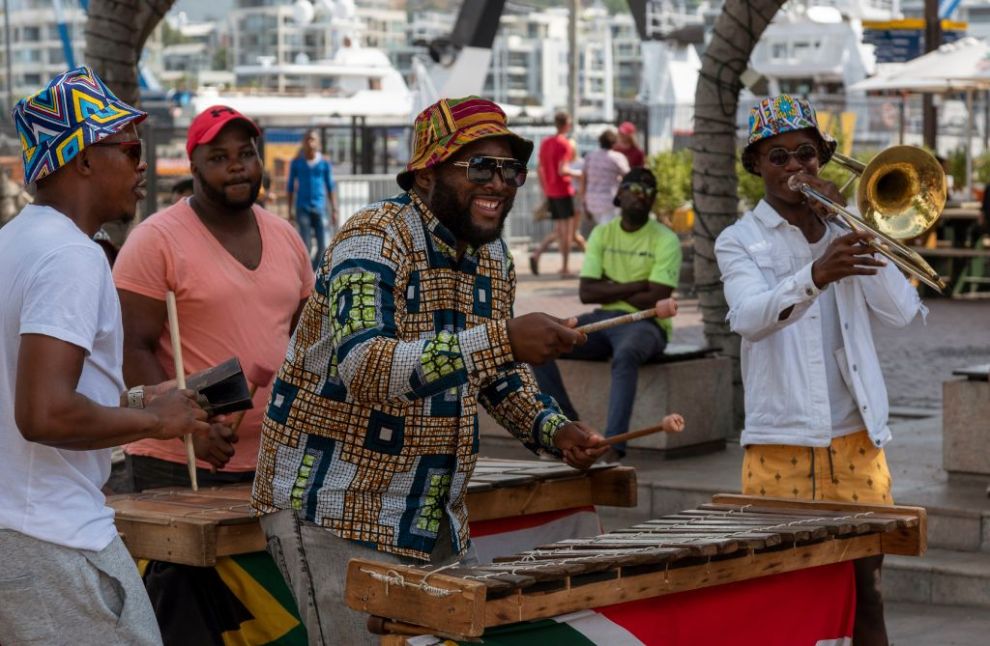 Cape Town, South Africa, Street musician in colorful clothing plays xylophone on the waterfront area of central Cape Town.