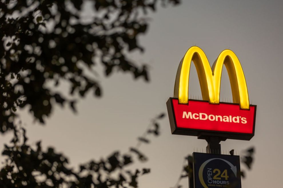 BRISTOL, UNITED KINGDOM - SEPTEMBER 11: The golden arches logo of the fast food restaurant McDonald's is illuminated, on September 11, 2024 in Bristol, England. Founded in 1940, American multinational fast food chain McDonald's Corporation, best known for its Big Mac hamburgers, cheeseburgers and french fries, is the world's largest fast food restaurant chain.