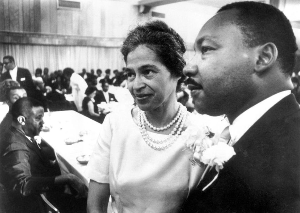 Dr. Martin Luther King stands with Rosa Parks at dinner given in her honor during Southern Christian Leadership Conference convention held here 8/10 in a previously segregated hotel. Mrs. Parks sparked the Montgomery bus boycott in 1956 that brought King his first national prominence in the civil rights movement.