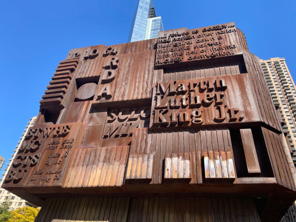 In New York City, a cube sculpture honoring Martin Luther King Jr. stands at the Martin Luther King Jr. Educational Complex, located at Amsterdam Avenue and W. 66th Street. The sculpture features text about King's life, his birth and death years, his family, and the renowned quote from his "I Have a Dream" speech: "Free at last, free at last. Thank God Almighty, I'm free at last.".